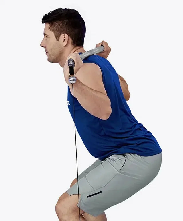 A man squatting with a bar across his shoulders and cables attached